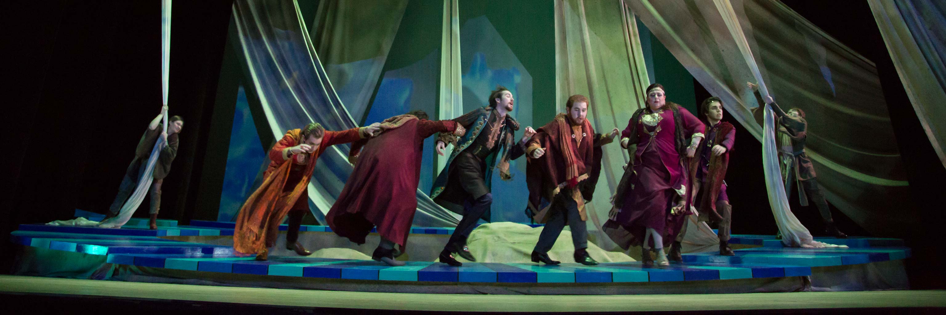 actors dancing on stage during performance.